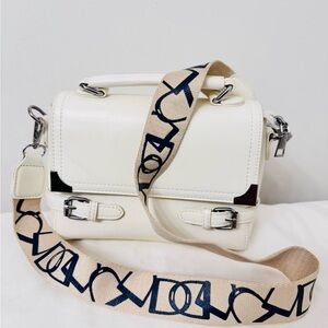 Off White Designer Crossbody Bag With a Tan and Blue Abstract Strap